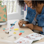 Woman crafting clay jewelry with stylish womens clothes in the Clay Jewelry Gift Kit