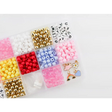 Colorful beads and craft supplies in the Color My World Bracelet Craft Kit for stretchy bracelets