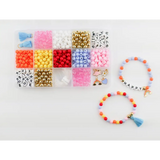 Bead organizer box filled with colorful beads and finished stretchy bracelets from Color My World Bracelet Craft Kit
