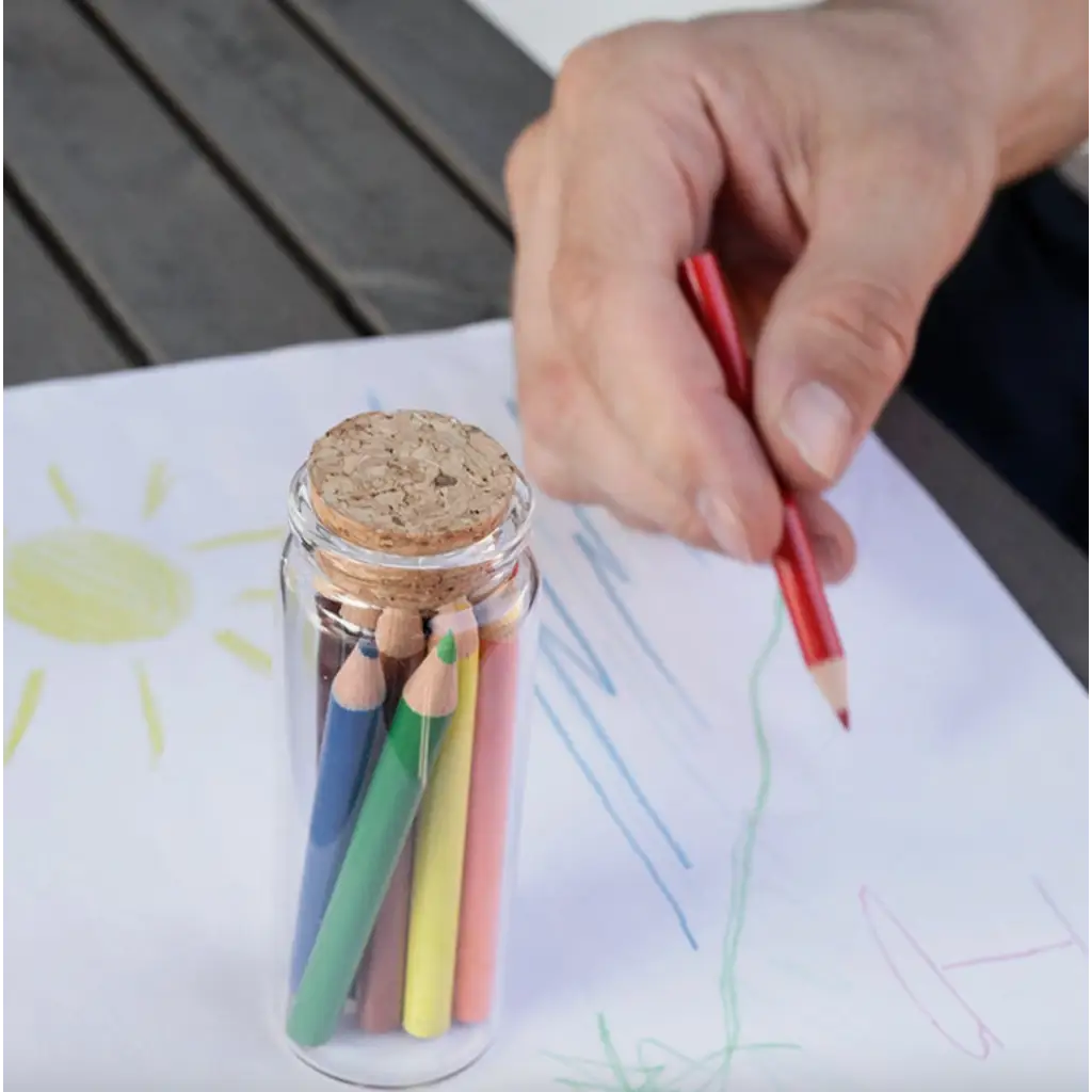 Miniature colored pencils in a glass jar for stylish womens clothes and polished prints