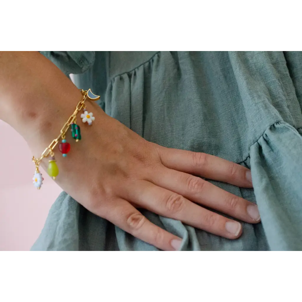 Gold-toned charm bracelet with colorful beads and daisy charms