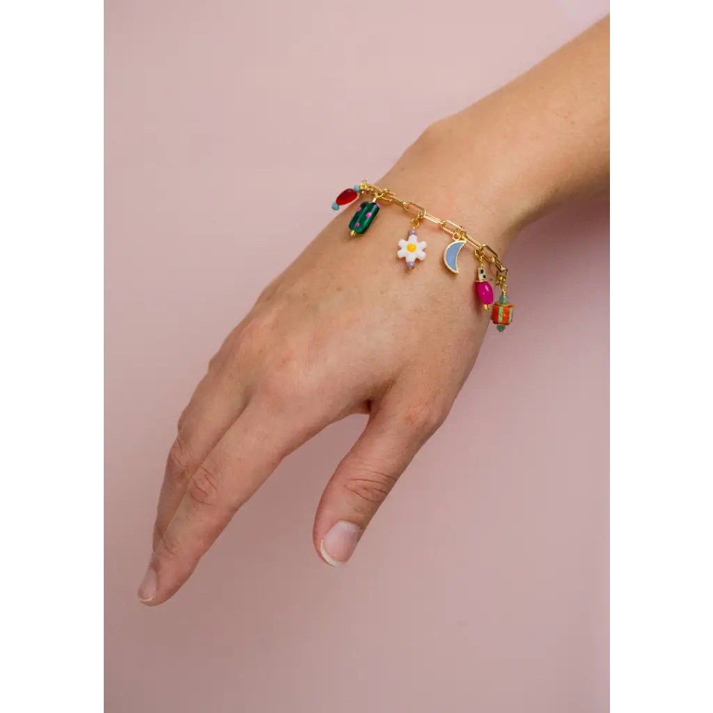 Gold-toned charm bracelet with colorful enamel daisy, moon, gift charms