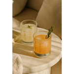 Two refreshing cocktails in Cowboy Cocktail Glasses with rosemary, perfect for peace signs camp