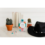 Black cowboy hat with cacti, books, and beads for a fun bracelet craft kit vibe