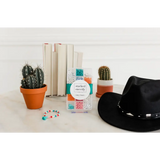 Black cowboy hat with cacti, books, and beads for a fun bracelet craft kit vibe