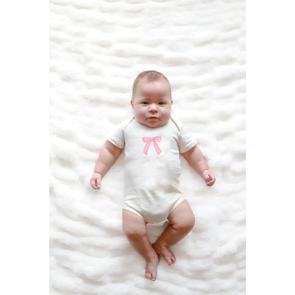 Cutesy Bow Baby Onesie in organic cotton with a cute pink bow and polished prints