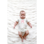 Cutesy Bow Baby Onesie in organic cotton with a cute pink bow and polished prints