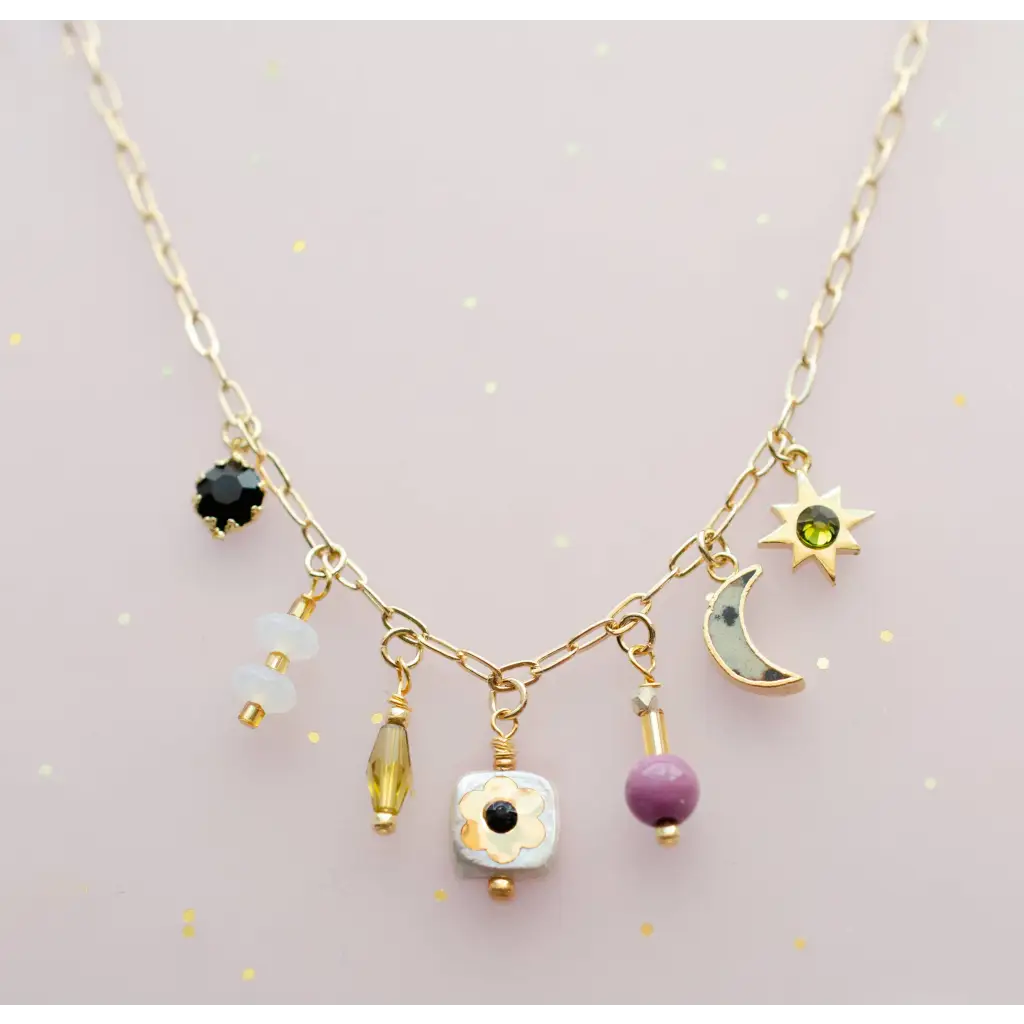 Dainty flower beaded charm necklace with gold celestial motifs and colorful gems