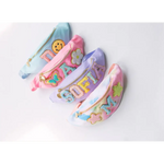 Four pastel-colored fanny packs with patches from the Design Your Own Bag Party Package at the craft bar
