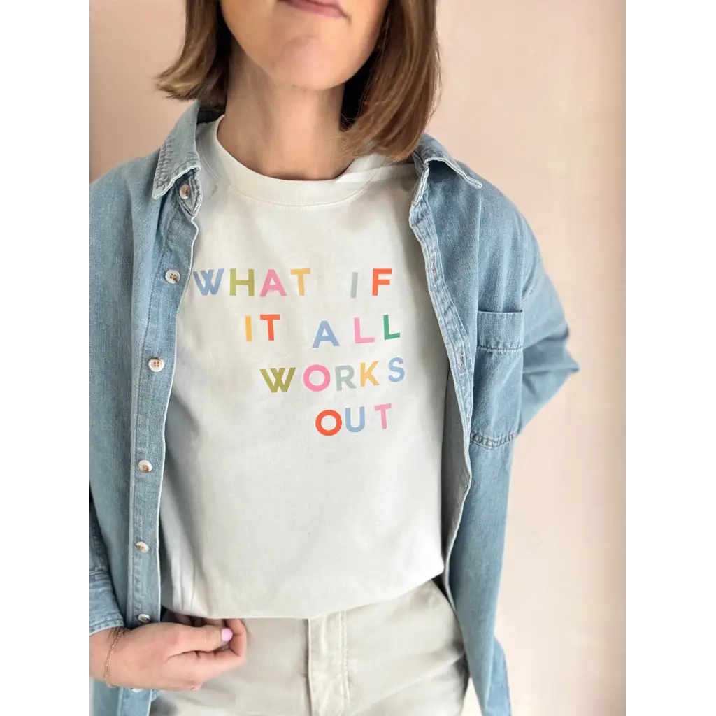 Light-colored short-sleeved T-shirt with colorful text worn under denim shirt at Craft Bar