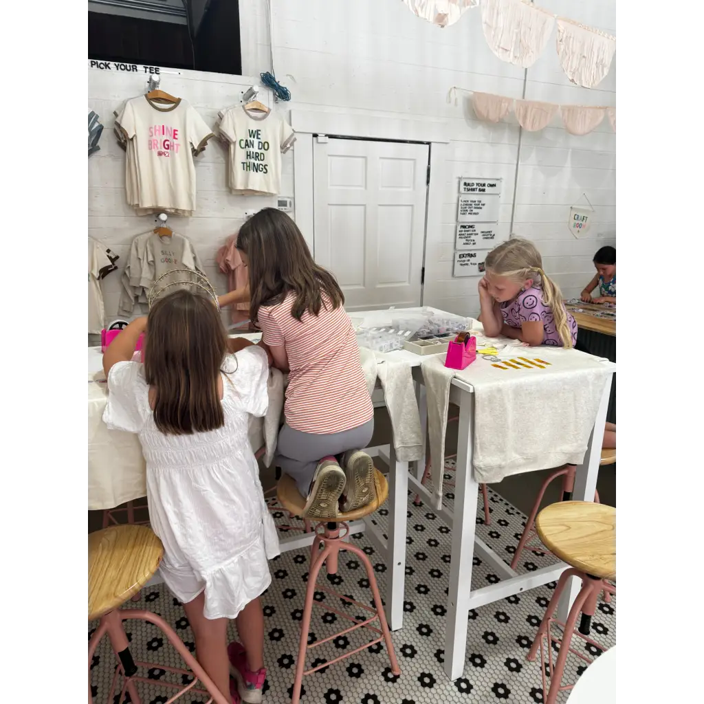 Kids having fun at the craft bar during a Design Your Own T-Shirt Party with a bar host