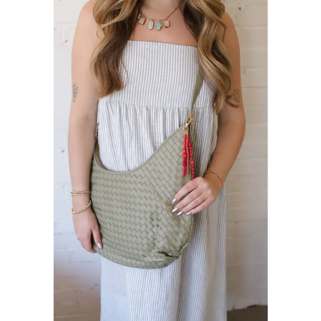 Pale green Diana Woven Bag XL in vegan leather with red tassel charm and two interior pockets
