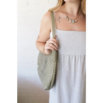 Woman in striped dress with Diana Woven Bag XL made of vegan leather, featuring two interior pockets