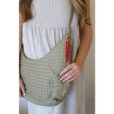 Light green Diana Woven Bag XL in vegan leather with two interior pockets and red beaded tassel