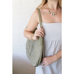 Woman in striped dress holding Diana Woven Bag XL with vegan leather, two interior pockets