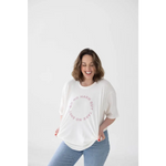 Cozy Relaxed Fit Graphic Tee with Polished Pink Text styled with light blue jeans