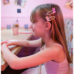 Young girl with long brown hair wearing Dolly Disco Cowgirl Boots with pink hair clips