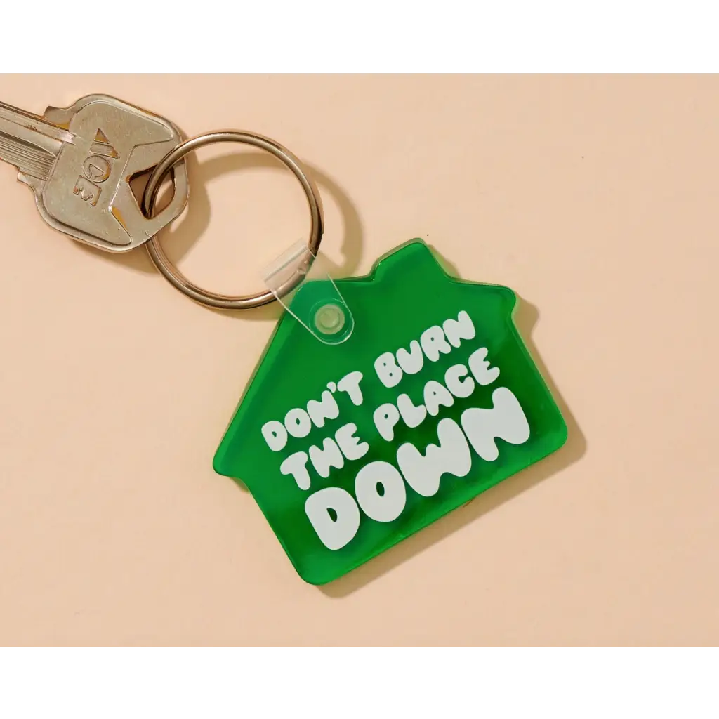 Green House shaped keychain for spare keys with Don’t Burn the Place Down message