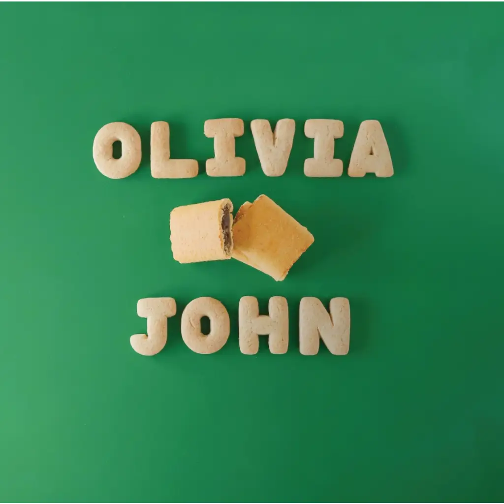 Cookie letters spelling Olivia and John with a broken cookie, perfect for Céline Dijon fans