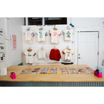 Clothing display at Edwardsville Craft Bar showcasing stylish outfits for shoppers