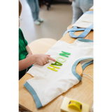 White t-shirt with blue trim and green NOAH lettering for Edwardsville Craft Bar fans
