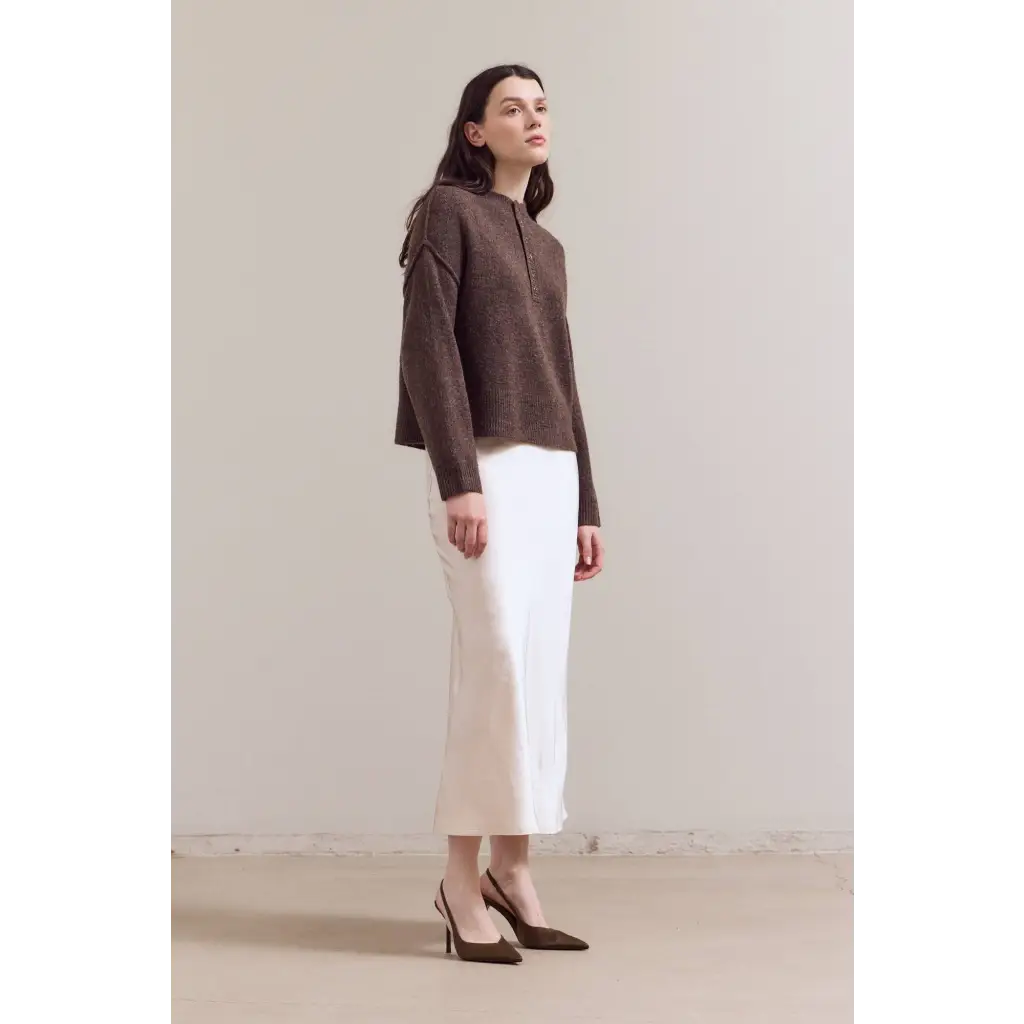 Brown textured Ellia henley sweater with white skirt and black heels