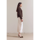 Stylish womens henley sweater with cream linen midi skirt and brown heels