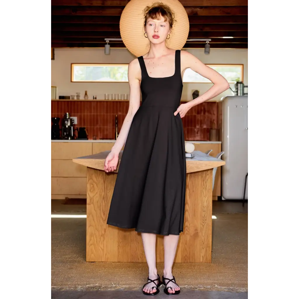 Woman in black Ellie Square Neck Fit and Flare Jersey Midi Dress made with stretchy jersey fabric