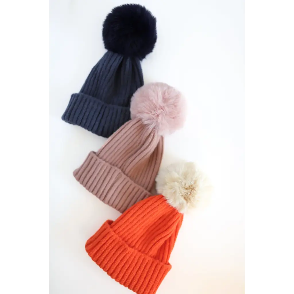 Three Eloise Pom Pom Beanies in navy, pink, and orange for stylish kids’ winter looks