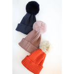 Three stylish Eloise Pom Pom Beanies for Kids & Baby in navy, pink, and orange colors