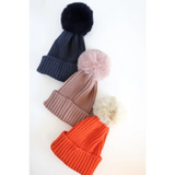 Three stylish Eloise Pom Pom Beanies for Kids & Baby in navy, pink, and orange colors