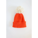 Orange knit Eloise Pom Pom Beanie for kids, perfect for stylish moms’ winter outfits