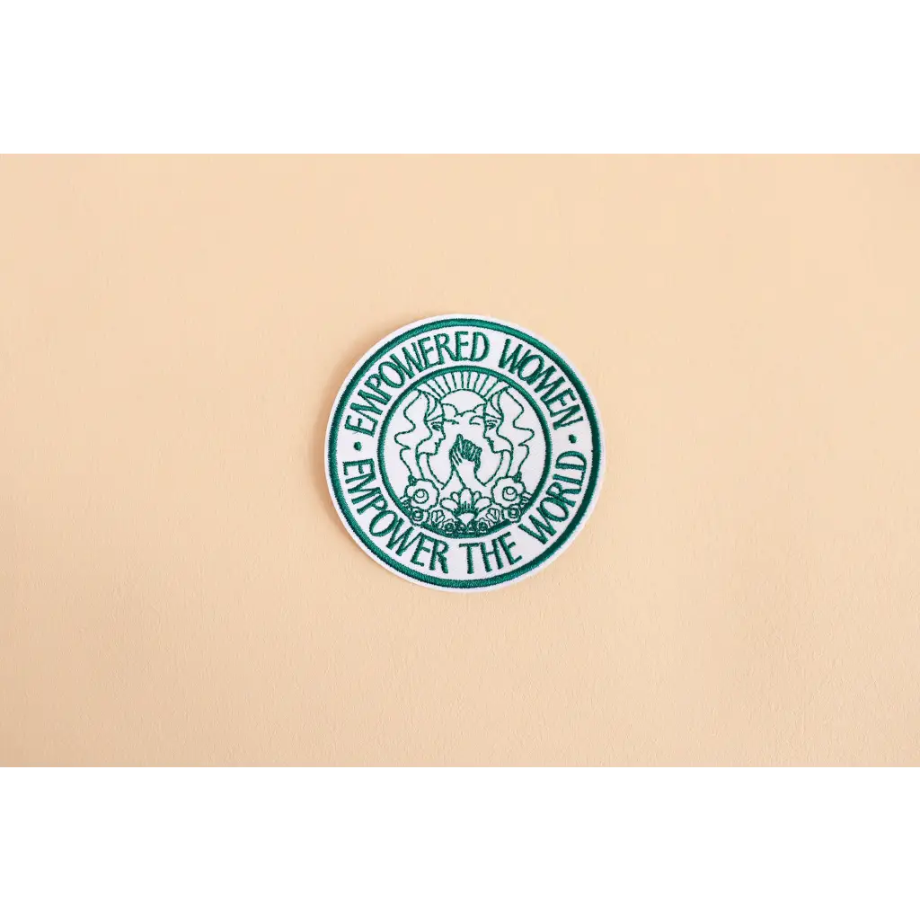 Circular green and white Empowered Women iron-on patch featuring a female symbol design