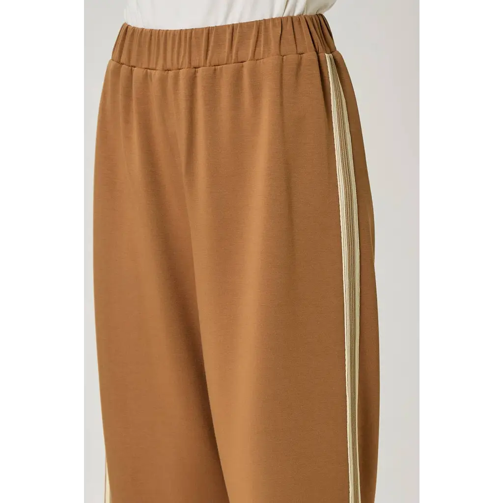 Olive green everyday tracksuit pants with tan wide-leg, elastic waist, and beige side stripe