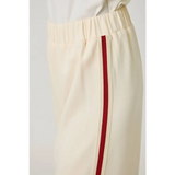 Olive green everyday tracksuit pants with cream trousers and red side zipper