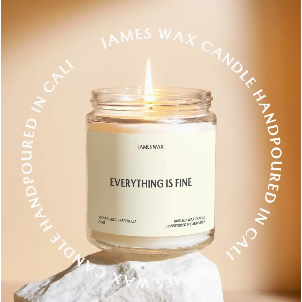 White candle in glass jar labeled Everything is Fine with pineapple sparkling citrus scent