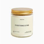 White candle in a jar with gold lid and Everything is Fine label, scented pineapple sparkling citrus