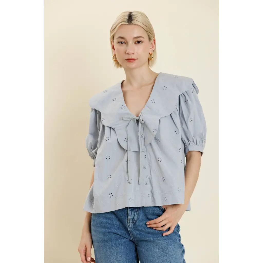 Women’s light blue eyelet blouse with ruffled collar and front tie, perfect stylish womens clothes