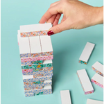 Stack of white blocks with floral washi tape for the Floral Tumbling Tower Game