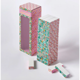 Floral Tumbling Tower Game features decorative pink and turquoise patterned boxes