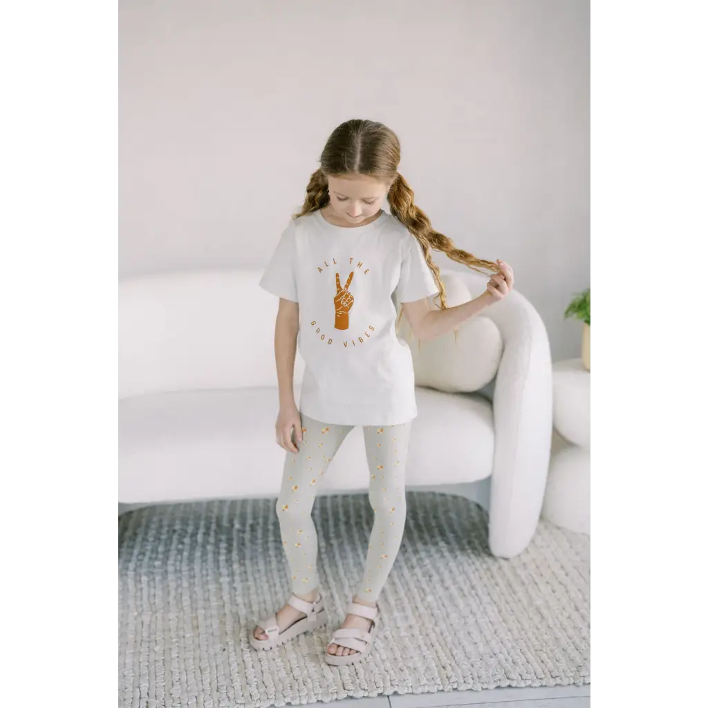 Child in Good Vibes White T-shirt and flexible lightweight Forest Dweller Leggings