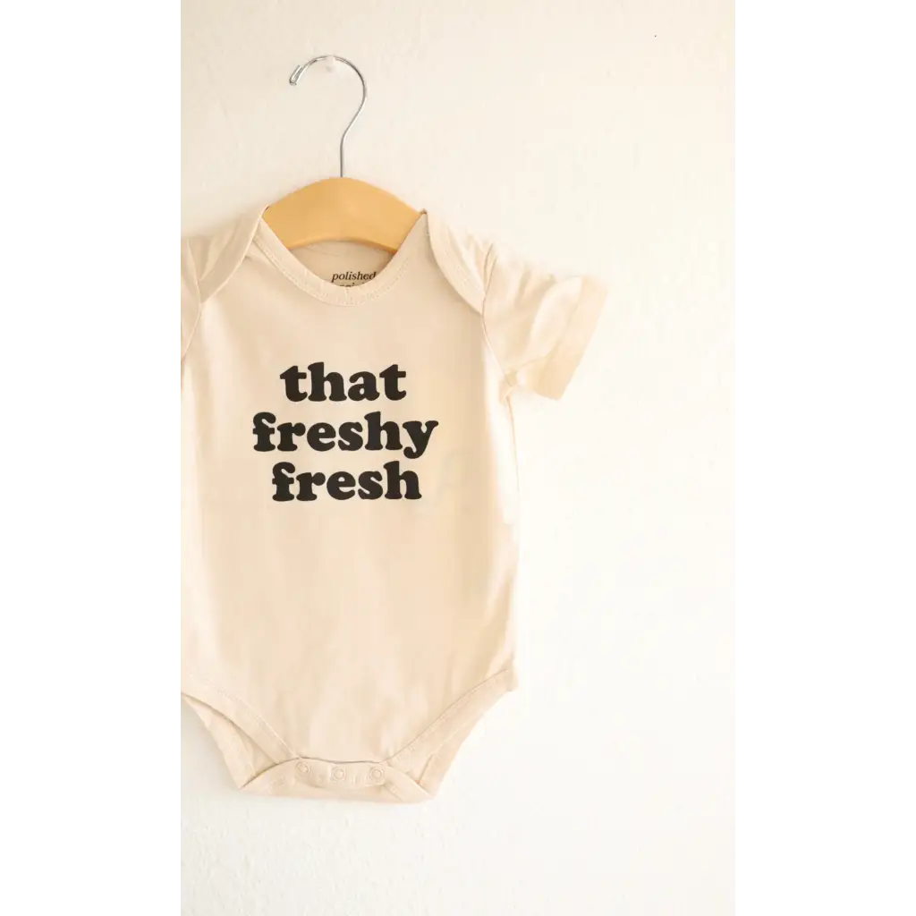 White baby onesie with freshy fresh text in black, made from organic cotton for 3mo fits