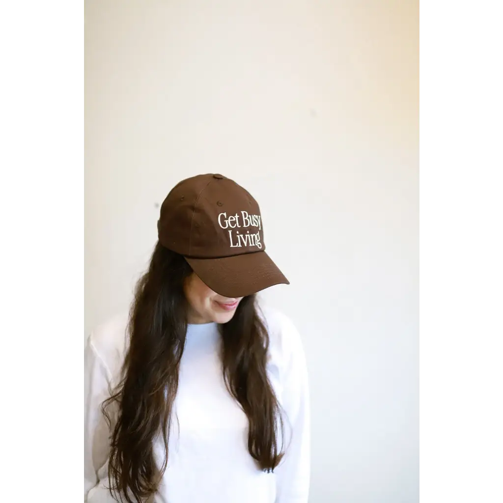 Brown embroidered baseball hat with Get Busy Living text for a stylish look