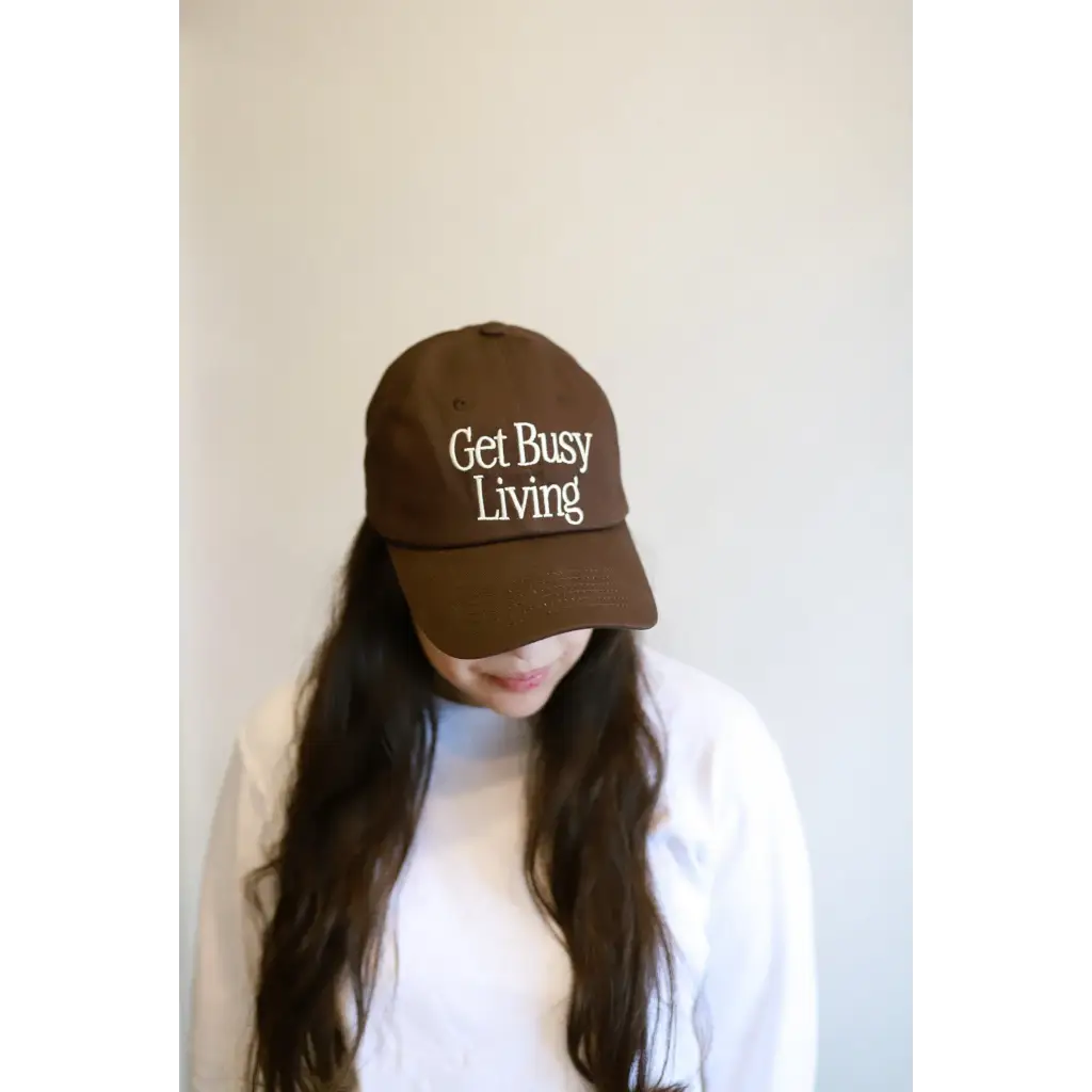 Brown Get Busy Living Embroidered Baseball Hat with cool text on the front