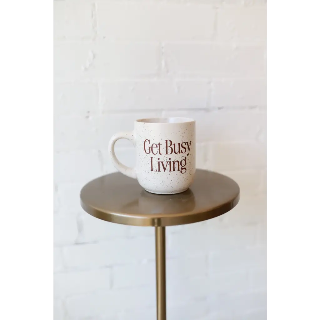 Speckled mug with motivational text for busy living in stylish womens clothes