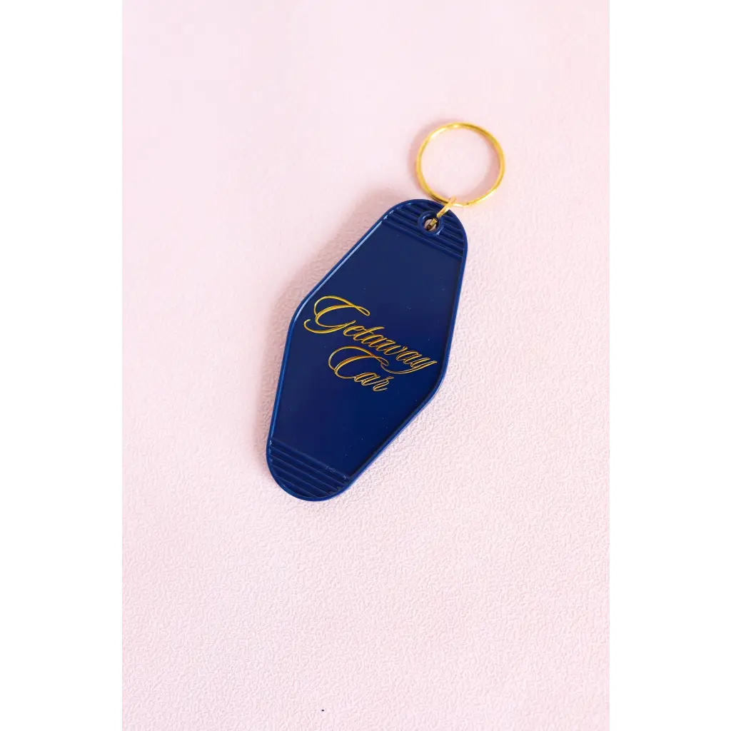 Navy blue vintage motel key tag with gold lettering for your getaway car vibes