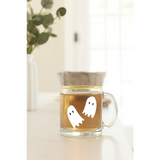 Clear glass mug with ghost decals, perfect for stylish womens clothes and polished prints