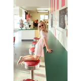 Pink Gingham All Day Twirl Dress with sunglasses at a retro diner counter