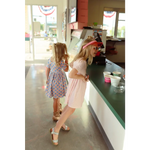 Two customers in summer dresses at a counter, showing off the Gingham All Day Twirl Dress