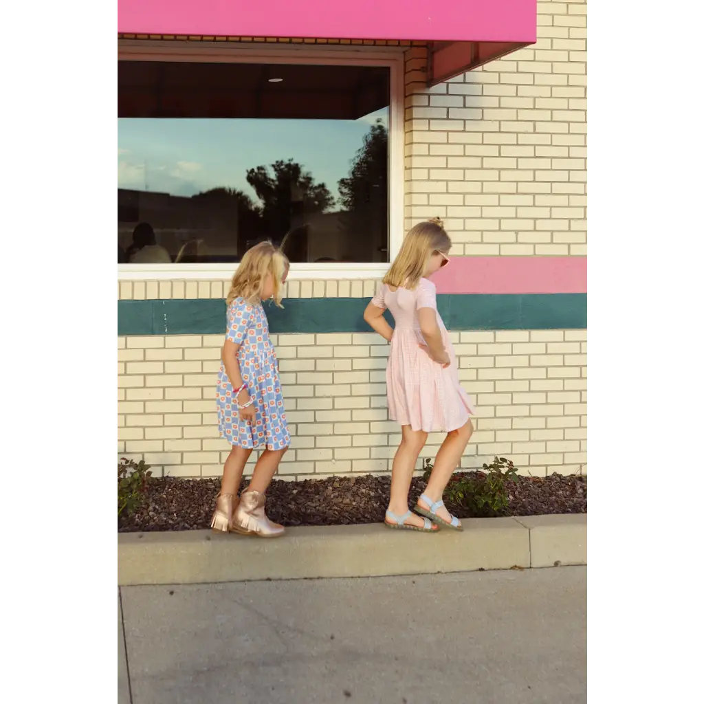 Two kids in summer dresses enjoying a walk in their Gingham All Day Twirl Dress